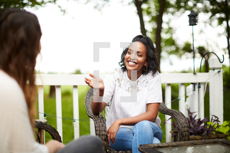 women talking on a patio