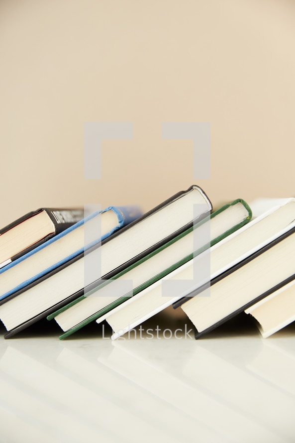 leaning row of books 