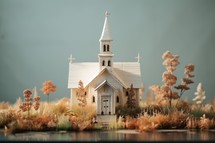 Miniature christian church on the lake. Selective focus.
