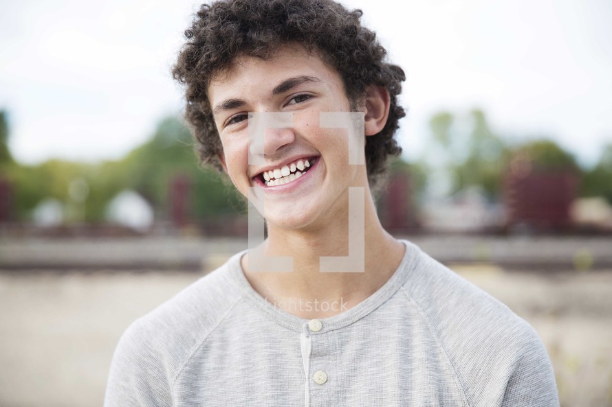 head shot of a smiling teen boy 