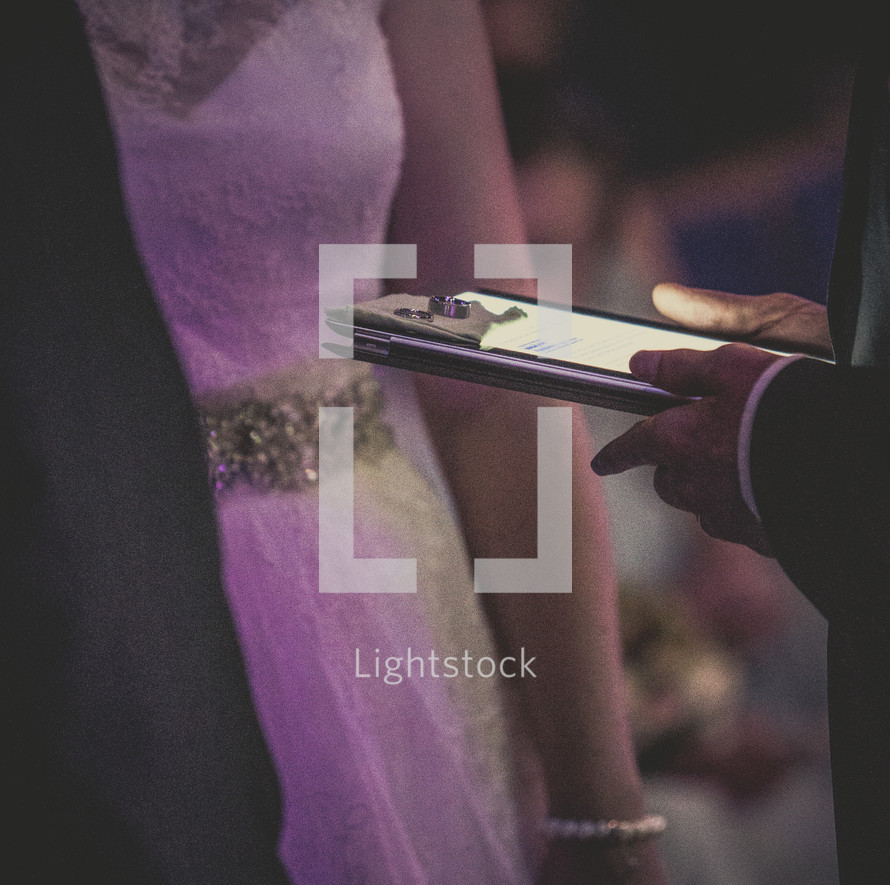 wedding rings presented to the bride and groom on an iPad 