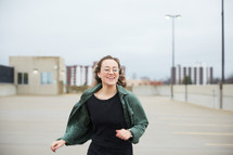 teen girl running in a parking deck 