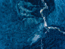 aerial view over frozen lake and islands, marble like 