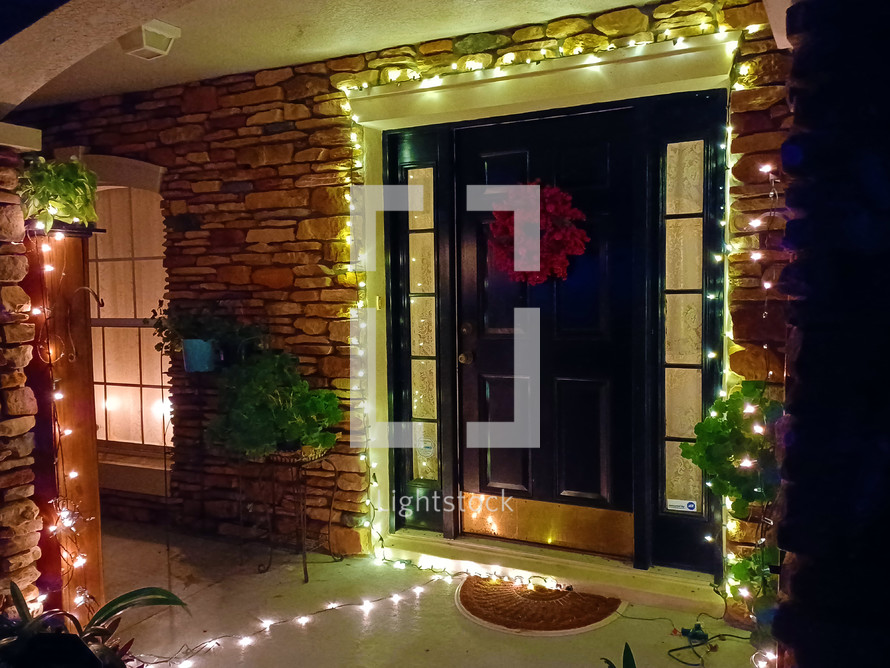 Christmas lights and wreath in entryway of home