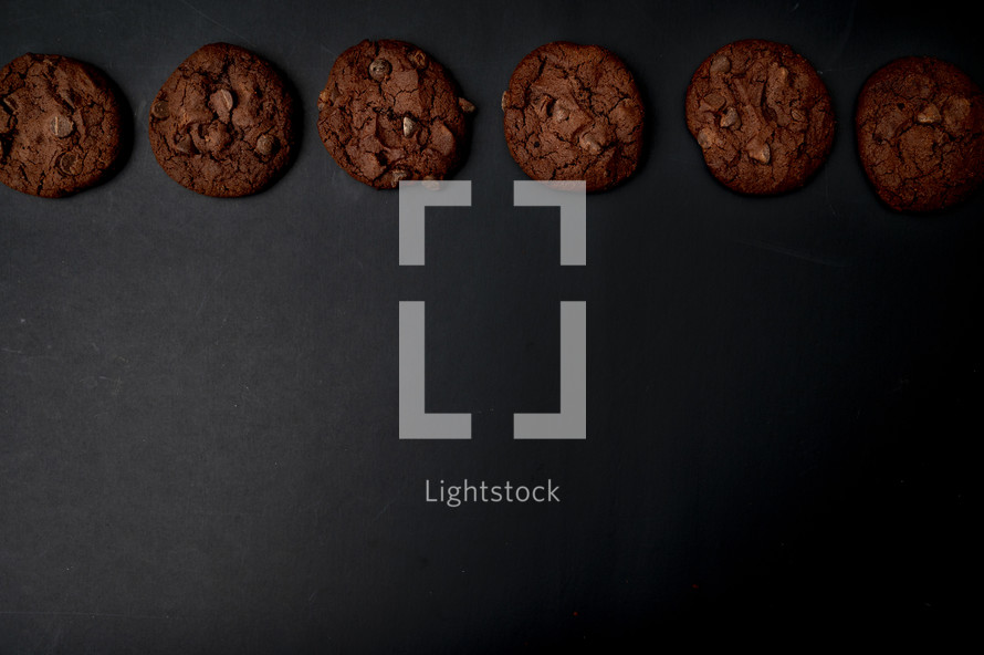 chocolate chocolate chip cookies on a black background 