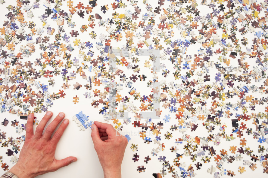 Point of view of a man assembling a jigsaw puzzle