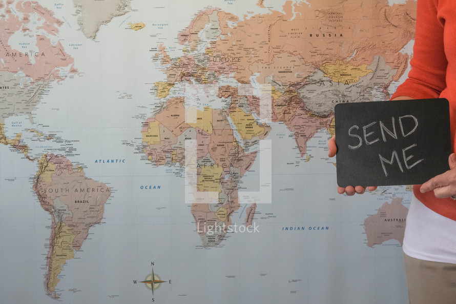 world map and woman holding a send me sign 