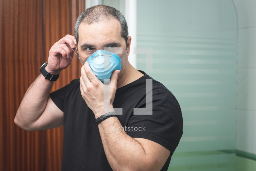 Portrait of sick man wearing facial hygienic mask. Coronavirus concept