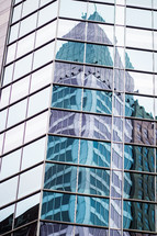 reflection in the windows of a skyscraper 