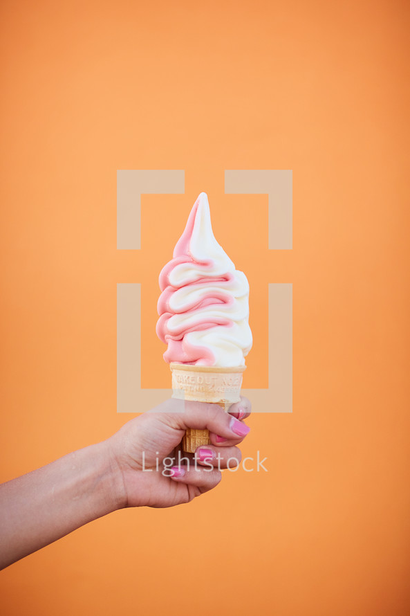 arm holding out an ice cream cone 