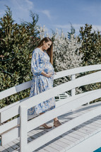 Pregnant woman on a bridge