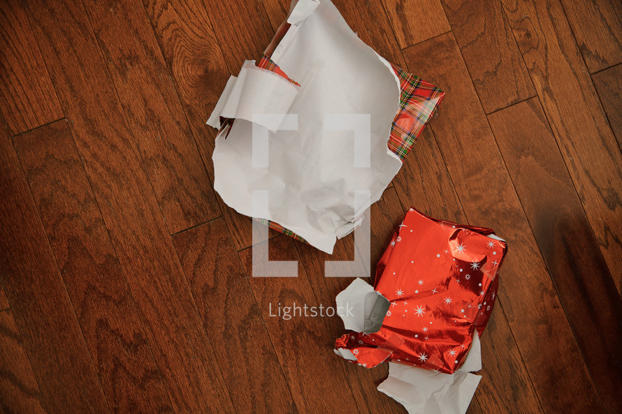 torn wrapping paper on the floor 