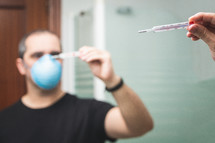 Portrait of sick man wearing facial hygienic mask 