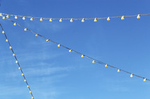 string of lights against a blue sky 