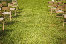 rows of folding chairs in grass