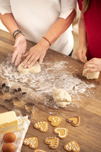 Baking Gingerbread for Christmas: Skilled Hands, mom and daughter baking Festive Holiday Delights