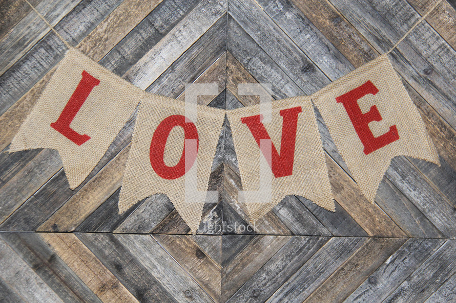 love banner on burlap against a wooden background
