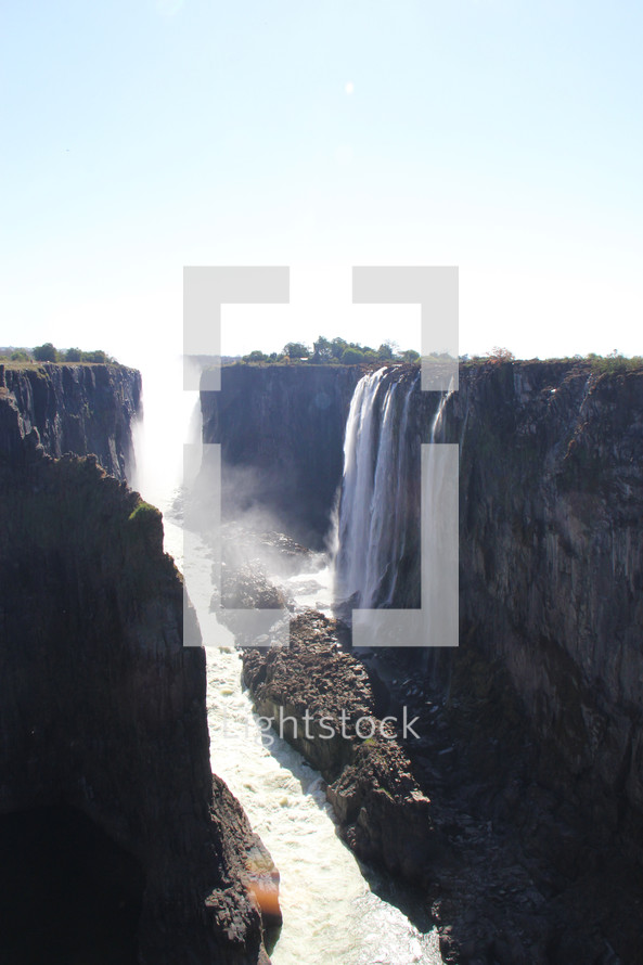 Victoria Falls  and Zambezi river flowing through a canyon 