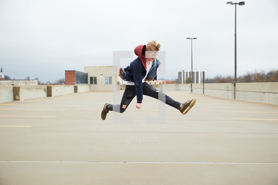 teen boy jumping up 