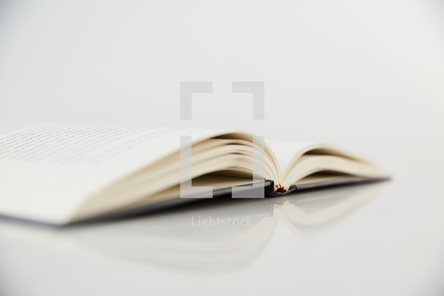 open book on a white table 