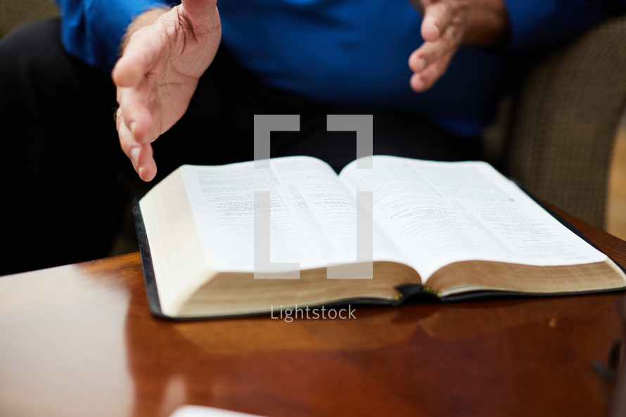 elderly man and Bible on a coffee table 
