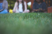 teen girl sitting in grass 