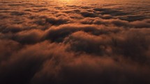 Magical sunrise view above the clouds