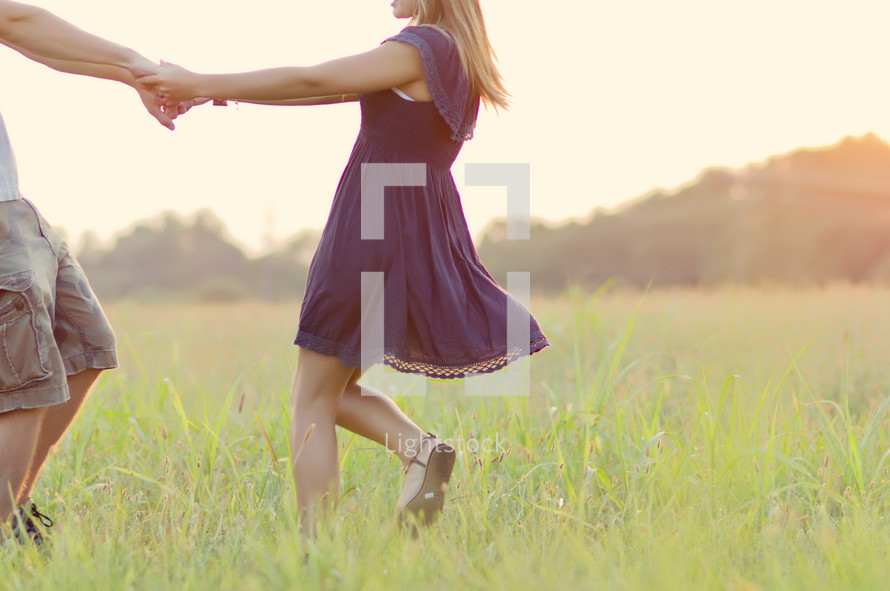 Couple dancing in a meadow.