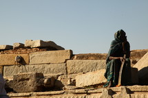 woman resting on a wall 