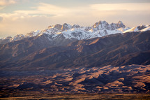 The Great Sand Dunes at the base of a mountain range.