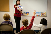 Teacher in a classroom presenting a lesson to students.
