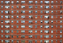 windows of a brick apartment building 