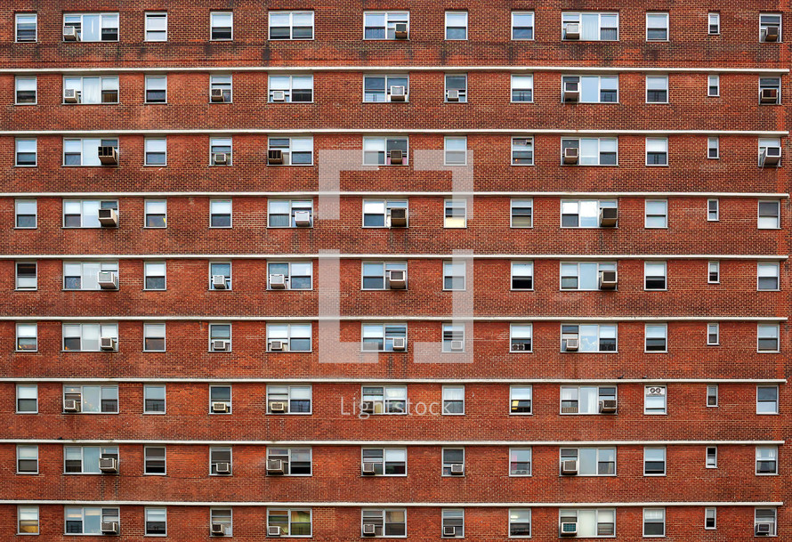 windows of a brick apartment building 
