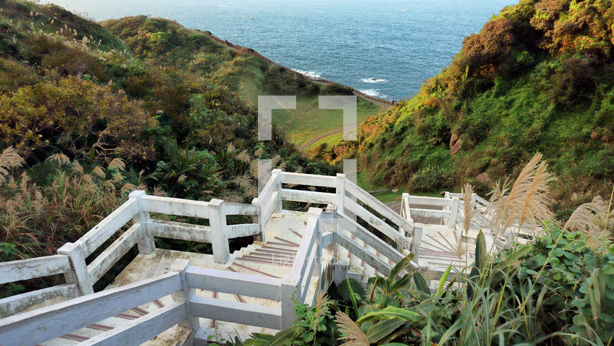 stairs and pathway leading to a beach 