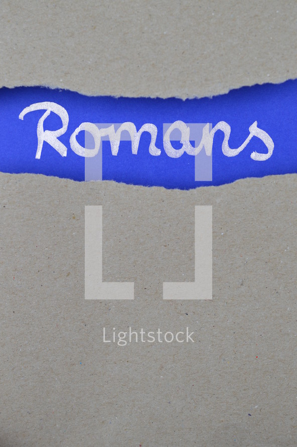 Romans - torn open kraft paper over intense blue paper with the name of the letter from Paul to the  Romans