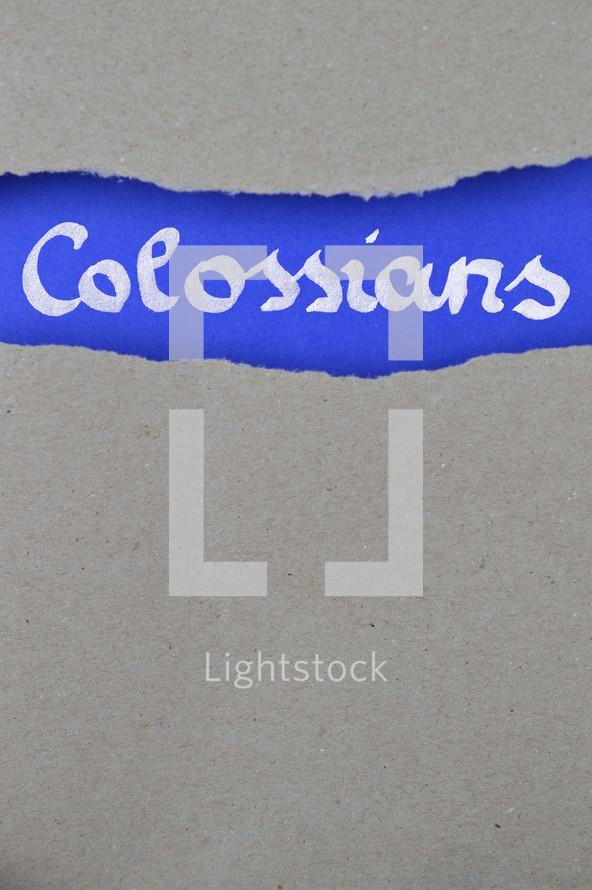 Colossians - torn open kraft paper over intense blue paper with the name of the letter from Paul to the Colossians
