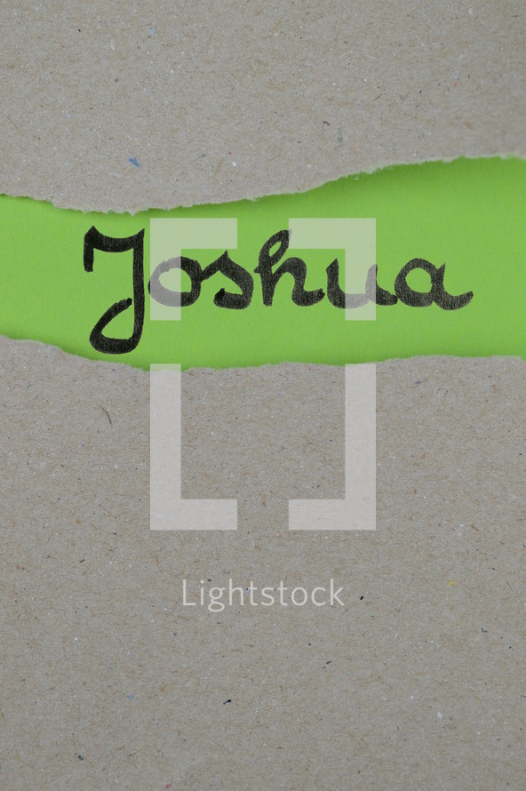 torn open kraft paper over green paper with the name of the book Joshua