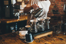 barista filtering coffee 