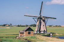 Old Dutch windmill and green fields