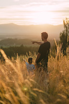 Father shows to son landscape