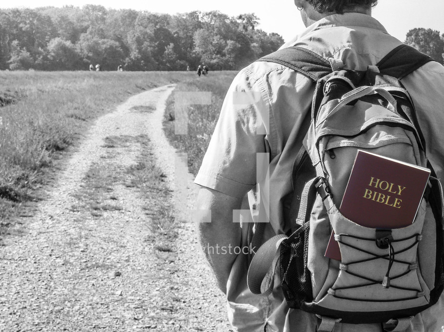 a boy with a Bible in his backpack 
