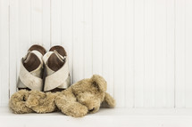 teddy bear and child's sandals 