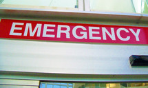A large red Emergency room sign at an area hospital emergency room entrance.  