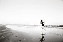 a woman running on a beach 