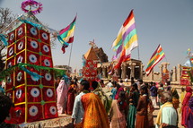 festival, outdoors, India, leaves, flags, man, woman, desert 