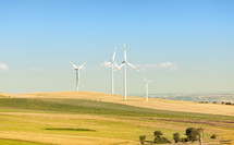 Wind turbines in operation in the summer with blue sky
