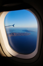 aerial view of Santorini island as seen from plane window.