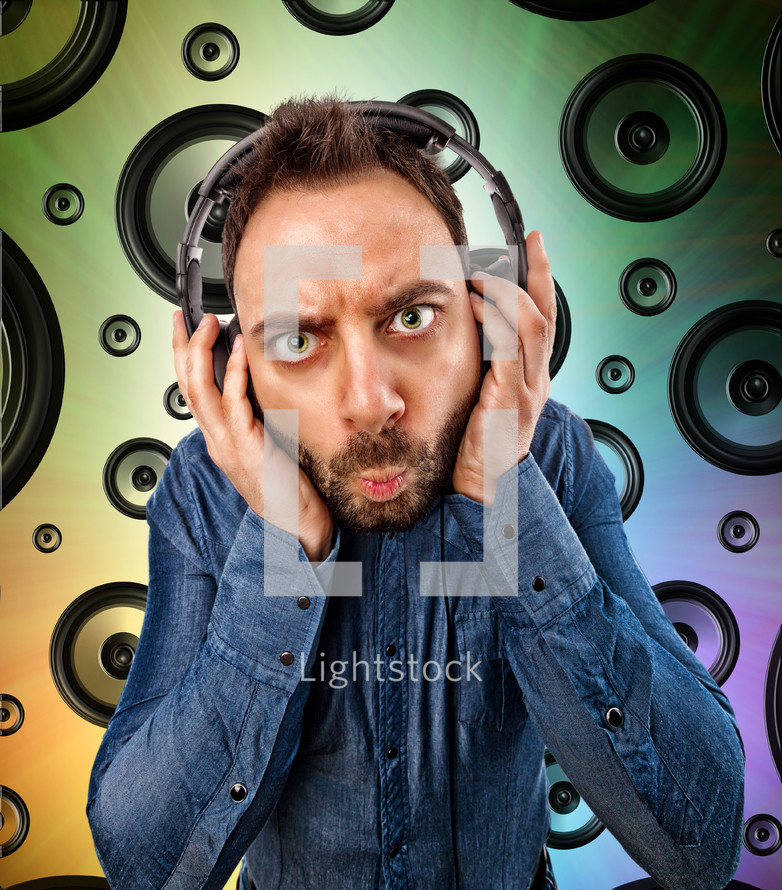 man with headphones and background with speakers