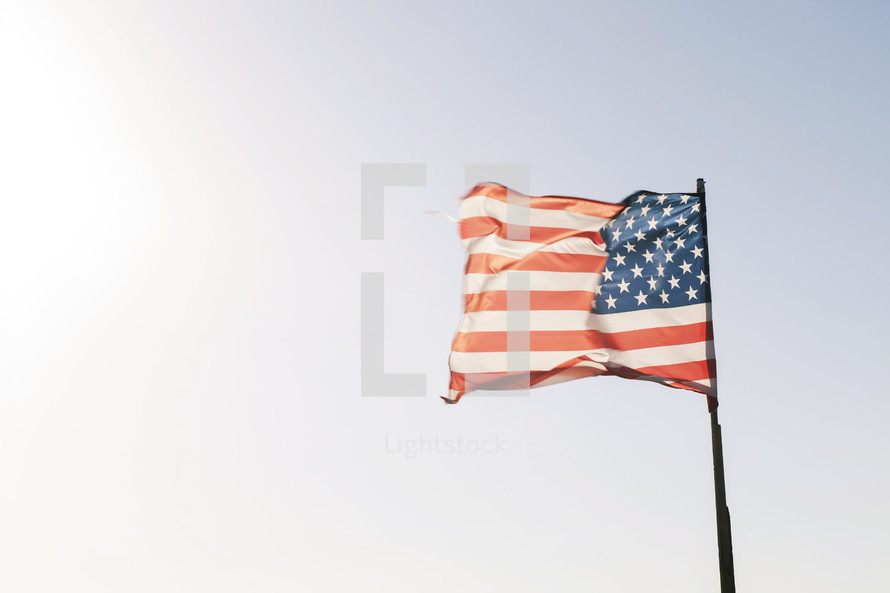 American flag on a wooden flag pole 