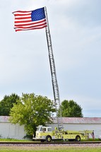 American flag at the top of a firetruck ladder 